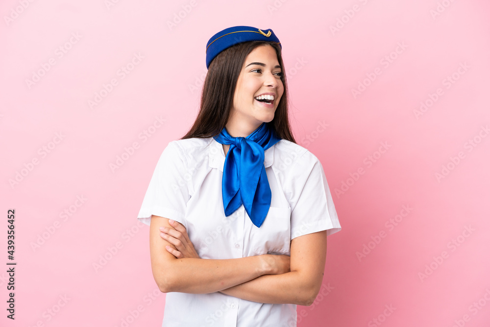 Airplane stewardess Brazilian woman isolated on pink background happy and smiling Airplane stewardess Brazilian woman isolated on pink background happy and smiling