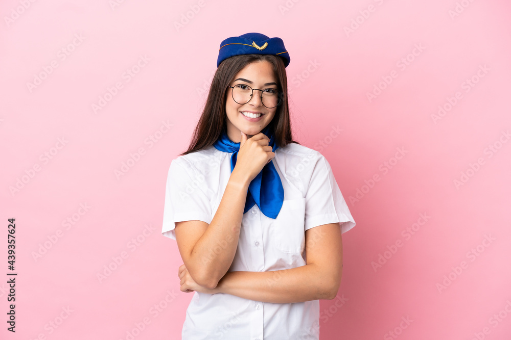 Airplane stewardess Brazilian woman isolated on pink background with glasses and smiling Airplane stewardess Brazilian woman isolated on pink background with glasses and smiling