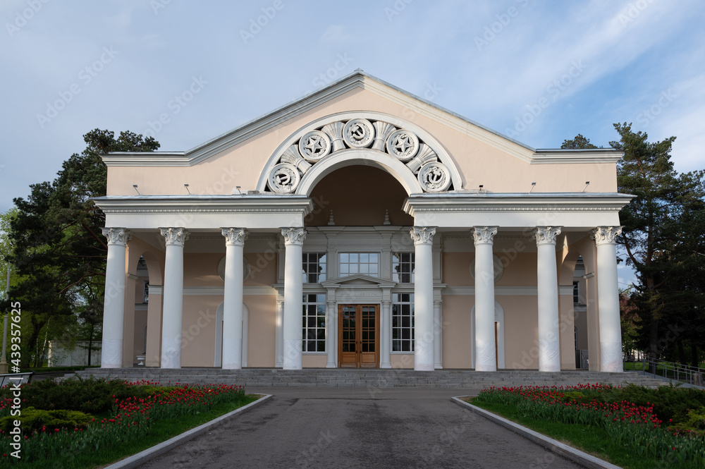 Building - example of soviet architecture with columns and soviet symbols. Inscription 