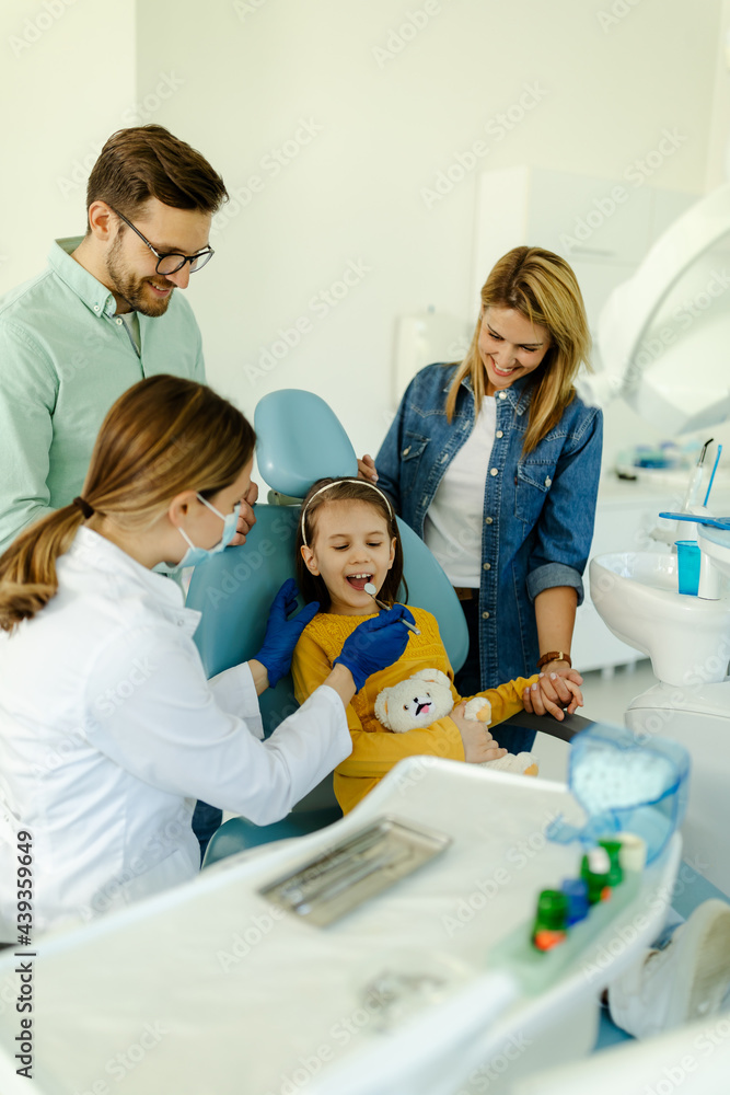 Female doctor with instruments in the hands looking girls teeth. Female doctor with instruments in the hands looking girls teeth.