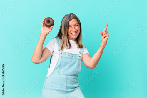 iddle age pretty woman with a donut photo