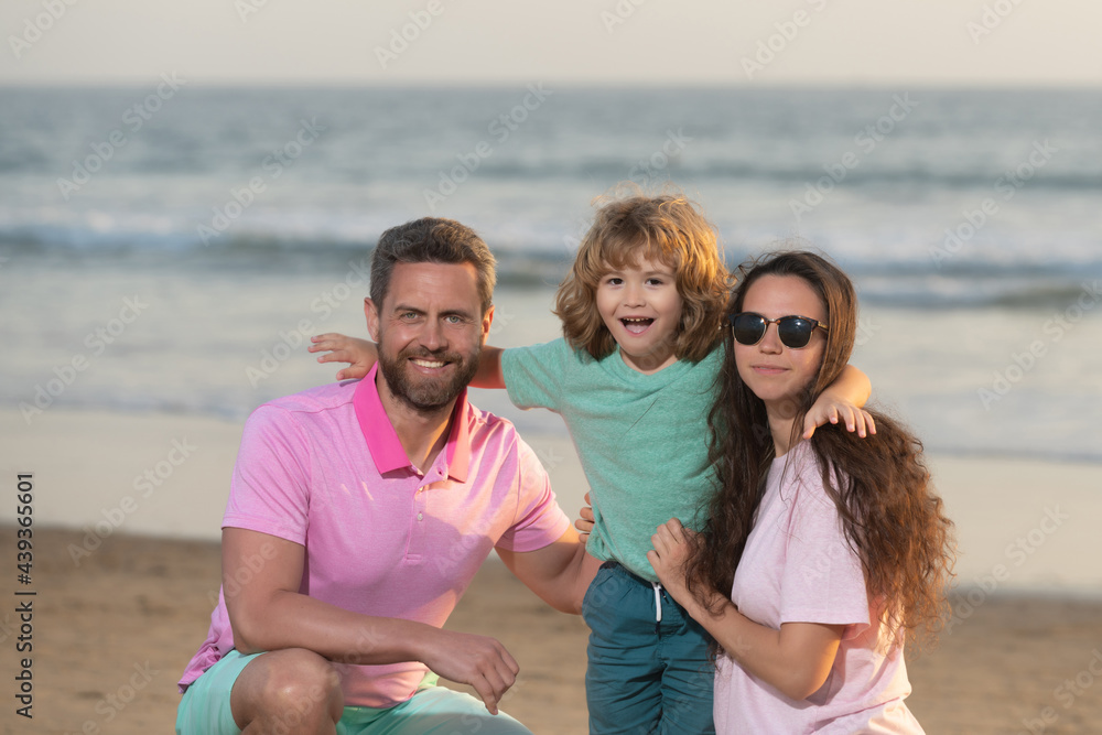 happy family portrait of mother father and son kid on malibu beach in summer vacation, family
