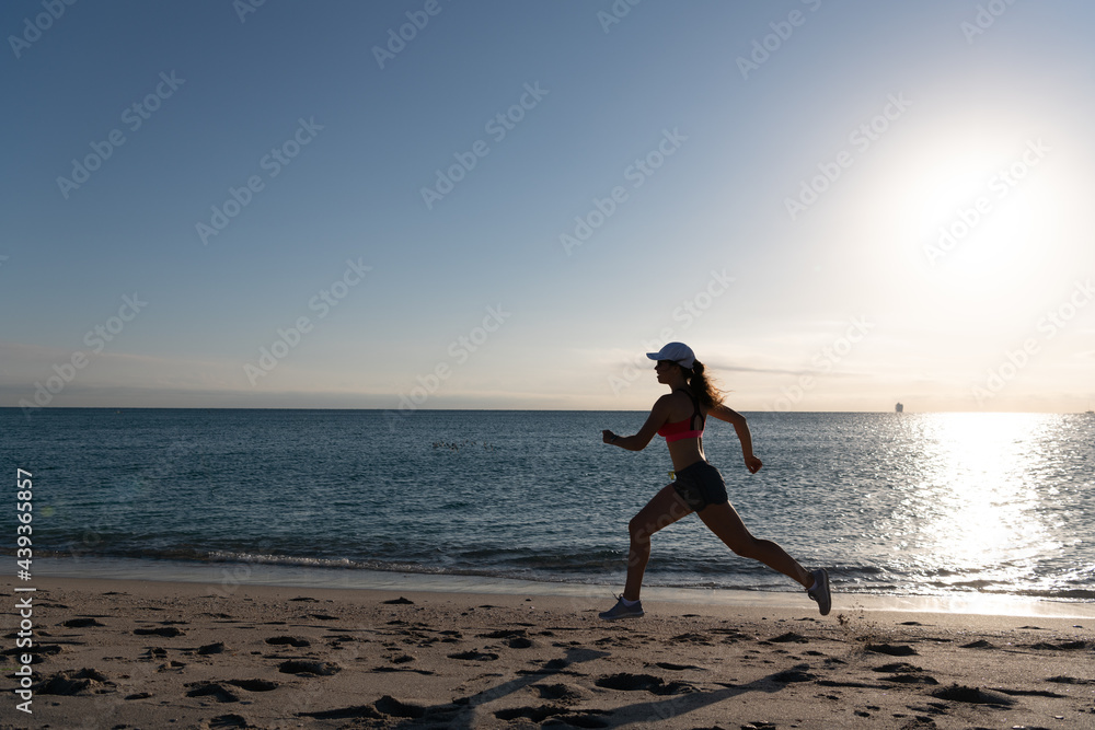 Running is my favorite. Fit girl run along seaside. Woman runner. Trail running. Jogging activities Running is my favorite. Fit girl run along seaside. Woman runner. Trail running. Jogging activities