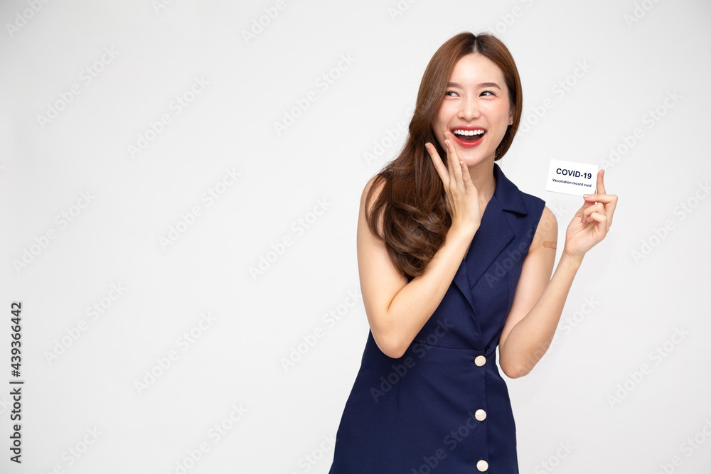 Beautiful Asian woman smiling and showing Covid-19 vaccination card is held in the hands isolated on white background Beautiful Asian woman smiling and showing Covid-19 vaccination card is held in the hands isolated on white background