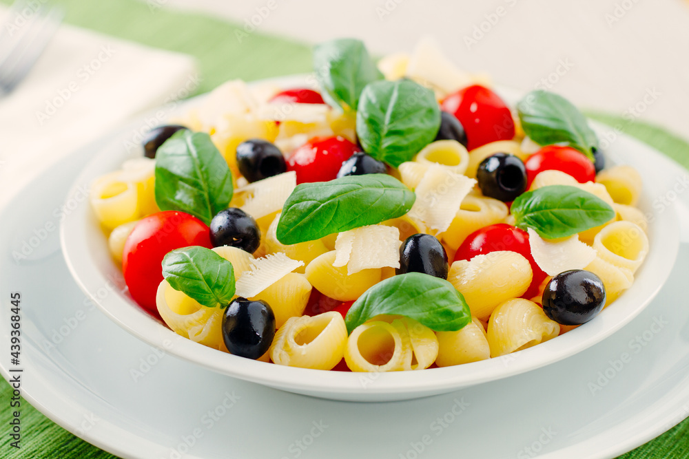 Fresh Pasta Salad with Tomatoes and Black Olives. High quality photo Fresh Pasta Salad with Tomatoes and Black Olives. High quality photo