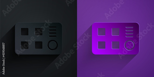 Paper cut Drum machine icon isolated on black on purple background. Musical equipment. Paper art style. Vector