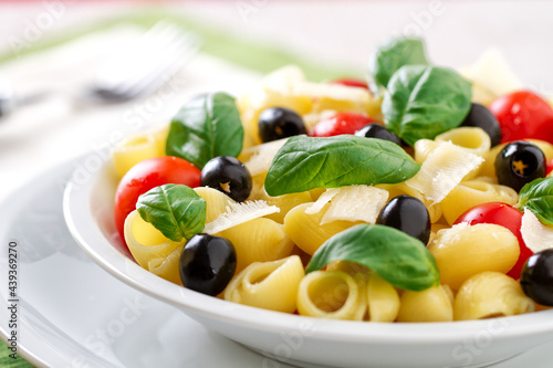 Fresh Pasta Salad with Tomatoes and Black Olives. High quality photo