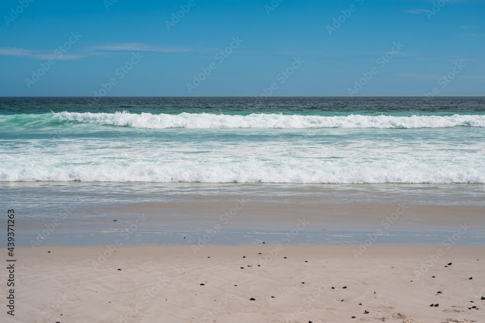 Ocean waves at sandy beach. Noordhoek beach in South Africa