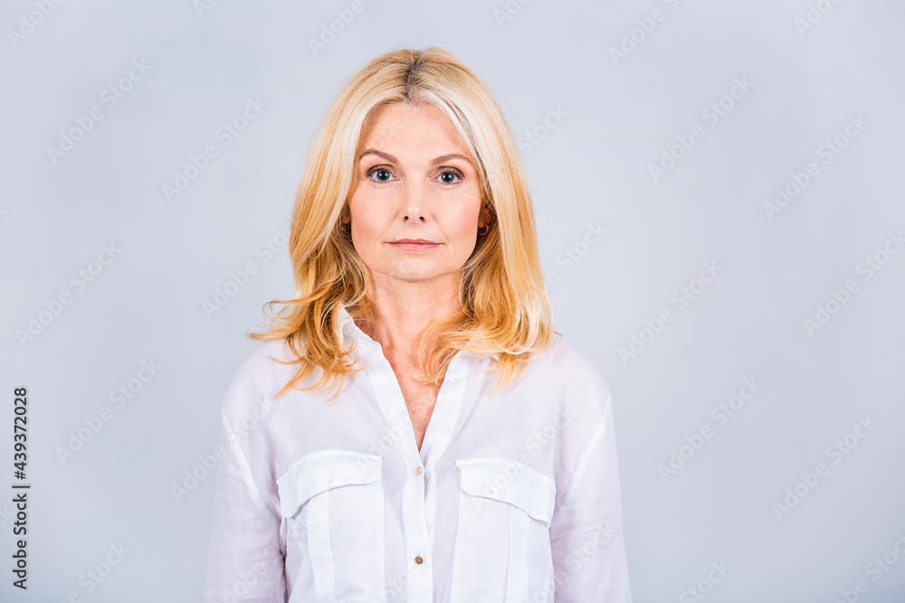 Happy elegant mature senior business woman smiling standing isolated on white background. Smiling confident cheerful middle aged lady with white smile looking at camera, copy space. Happy elegant mature senior business woman smiling standing isolated on white background. Smiling confident cheerful middle aged lady with white smile looking at camera, copy space.