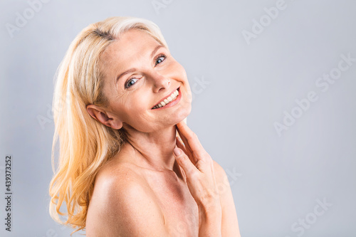 Close up portrait of a beautiful  attractive  charming  naked  nude woman touching her perfect skin  isolated on white background  after shower  peeling  lotion  mask  wellness  moisturizing concept.