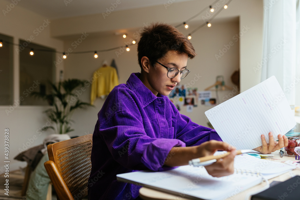 Intelligent kid doing homework in cozy own room Intelligent kid doing homework in cozy own room