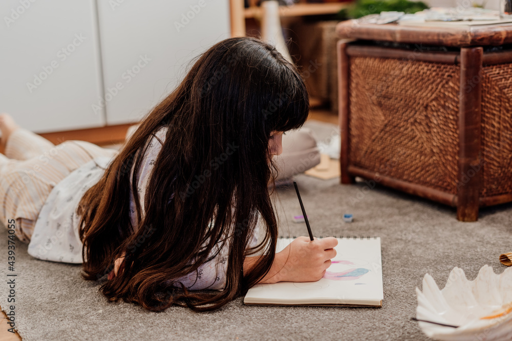 little girl drawing lying on the floor at room Stock Photo | Adobe Stock