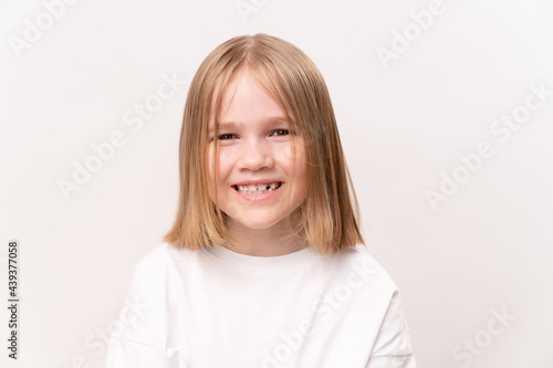 cheerful and happy little girl with a haircut quad on a white background. happy childhood. vitamins and medicine for the child.