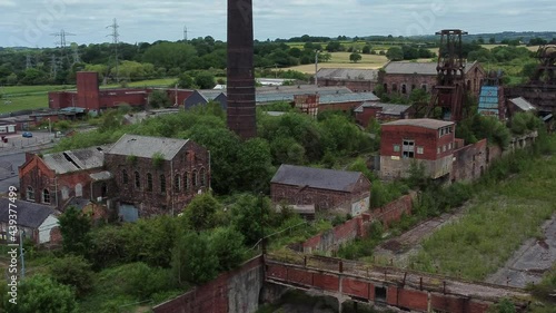 Wallpaper Mural Abandoned old overgrown coal mine industrial museum neglected buildings aerial view low orbit right Torontodigital.ca