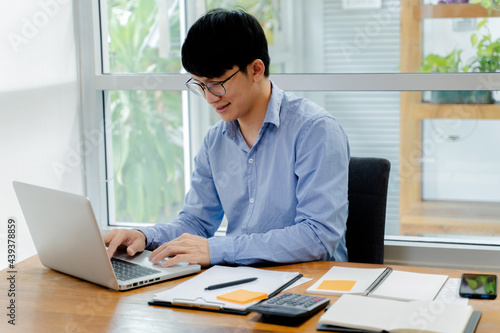 Close up of businessperson using laptop working with digital data..