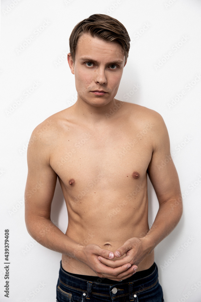 Portrait of handsome young and sexy man guy topless naked torso metrosexual hot tender body wear jeans isolated white background.