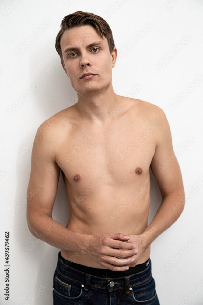 Portrait of handsome young and sexy man guy topless naked torso metrosexual hot tender body wear jeans isolated white background.