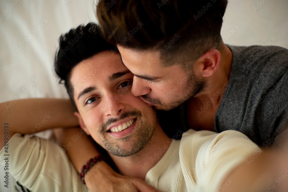 Young man kissing boyfriend on selfie Young man kissing boyfriend on selfie