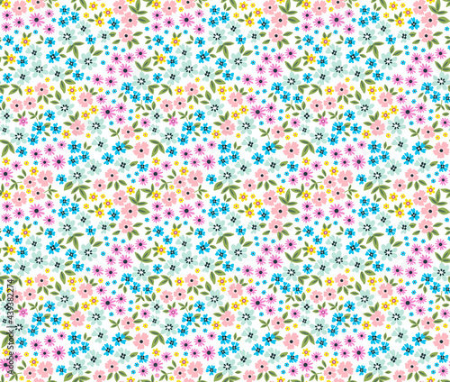 Ditsies floral pattern. Ditsy background of small colorful flowers. Small-scale flowers scattered over a white background. Stock vector for printing on surfaces and web design.