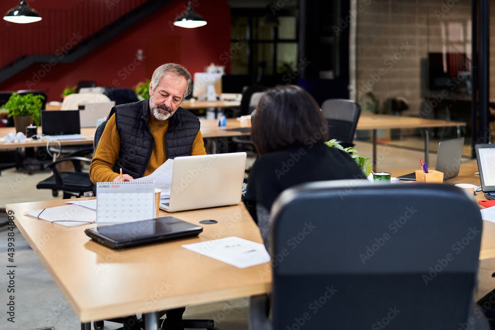 Mature employee working with documents Mature employee working with documents