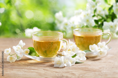 cups of jasmine tea and fresh jasmine flowers