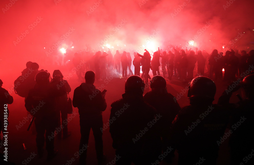 Police looking at football fans with torches