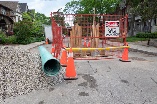 Photography Road Closed, men at work signage:  Pipes and fixtures used in a project to replace and upgrade basic drinking water infastructure in an older Toronto neighbourhood