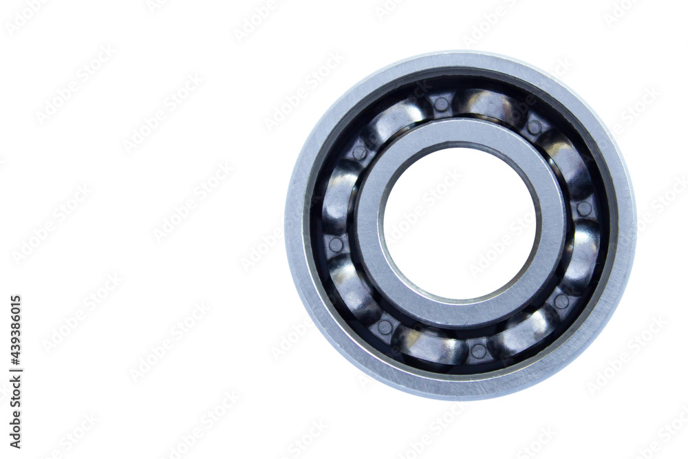 Ball bearing with steel cage close-up on a white background. The bearing is located on the right. Isolated. Copy space. Ball bearing with steel cage close-up on a white background. The bearing is located on the right. Isolated. Copy space.