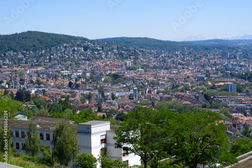 Panorama view over the City of Zurich with mountains in the background at a beautiful summer day. Photo taken June 14th, 2021, Zurich, Switzerland.
