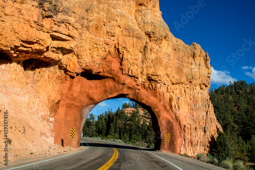 Drive-through red stone arch over highway in Red Rock Canyon Utah.