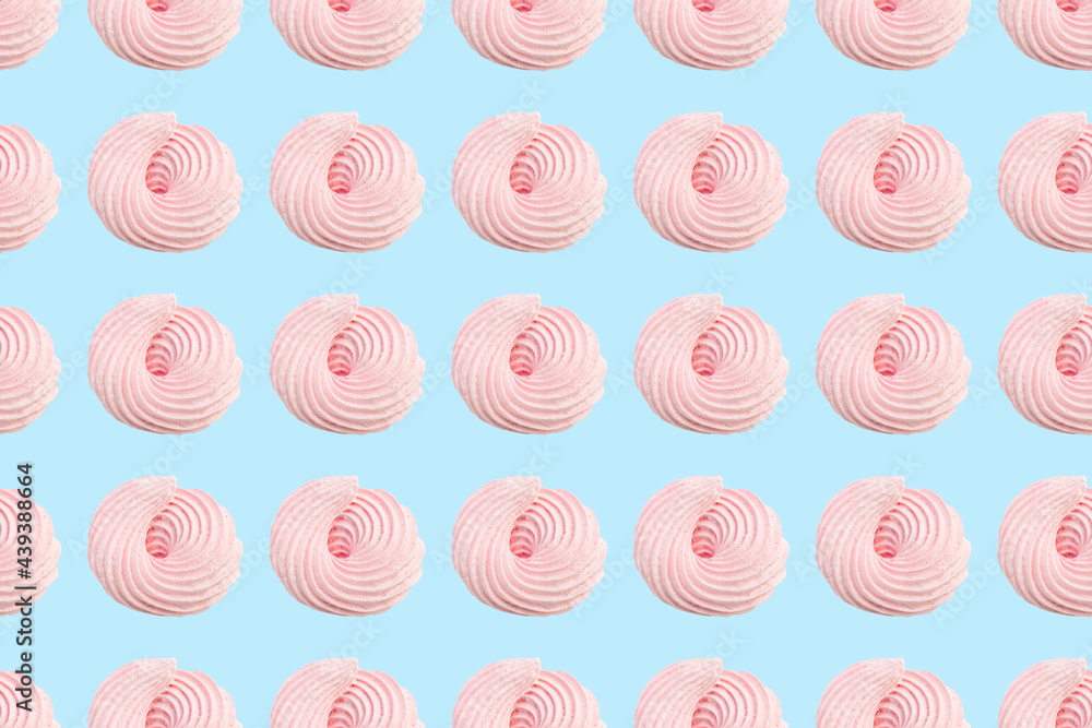 Pink meringue candy pastel colors seamless pattern light blue background. French pastries, sweet swirls of zephyr. Whipped egg cream and sugar dessert. Wallpaper, textiles, wrapping paper print