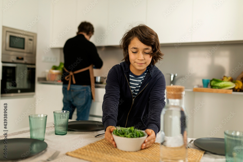 kid serving salad on lunch table kid serving salad on lunch table