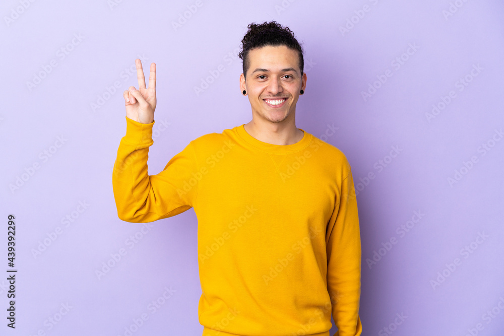 Caucasian man over isolated background smiling and showing victory sign Caucasian man over isolated background smiling and showing victory sign