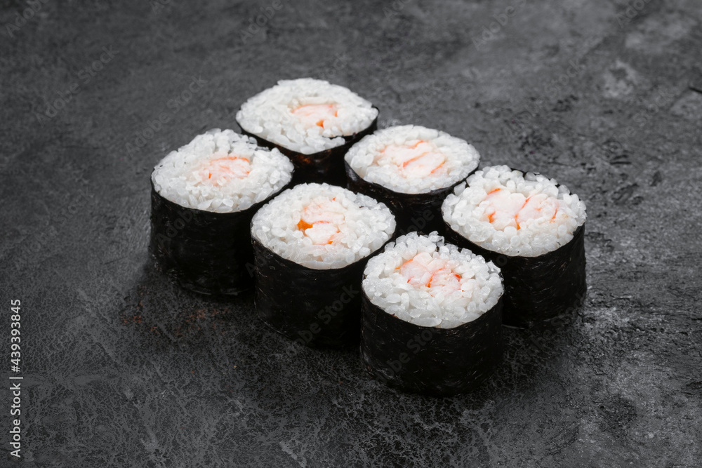 Sake maki Japanese roll with shrimp on stone. Ebi sushi-roll, close up Sake maki Japanese roll with shrimp on stone. Ebi sushi-roll, close up