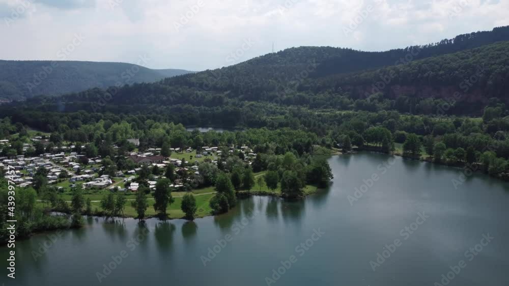 Camp of tourists by a beautiful blue lake Camp of tourists by a beautiful blue lake