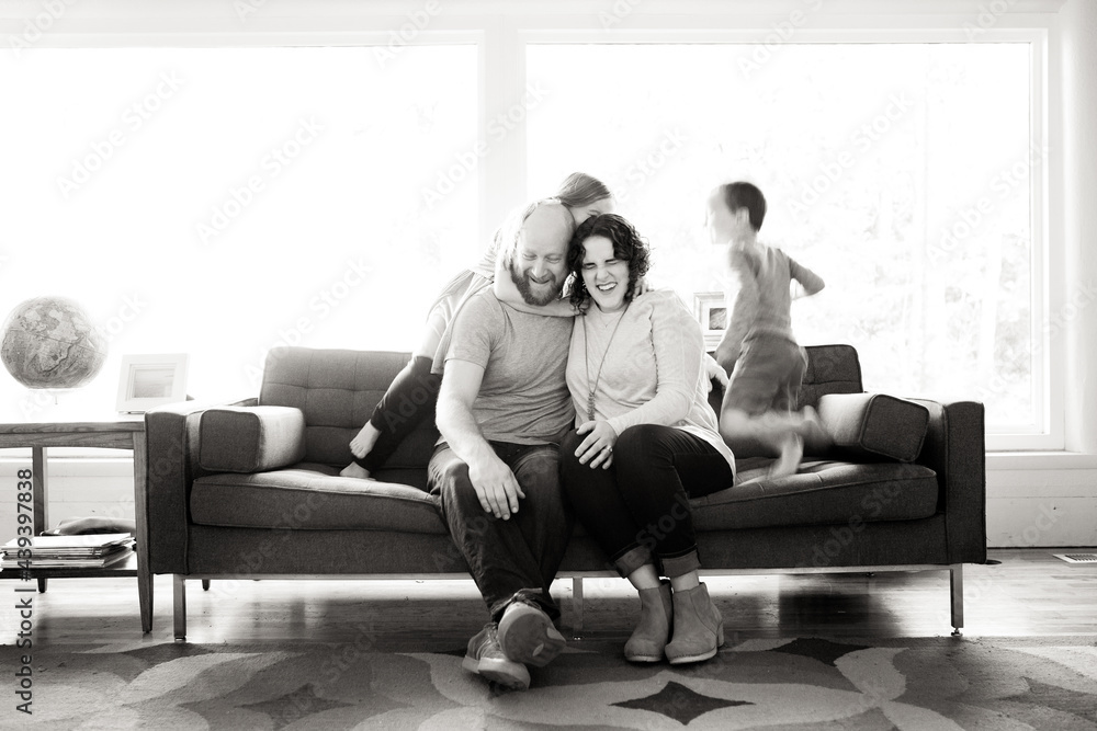 Laughing parents with blurred children Laughing parents with blurred children