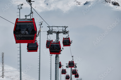 Gondola type ropeway on the slope of ski resort above clouds. Erciyes ski resort. Kayseri, Turkey photo