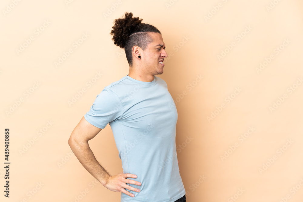 Caucasian man over isolated background suffering from backache for having made an effort Caucasian man over isolated background suffering from backache for having made an effort
