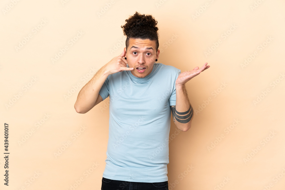 Caucasian man over isolated background making phone gesture and doubting Caucasian man over isolated background making phone gesture and doubting