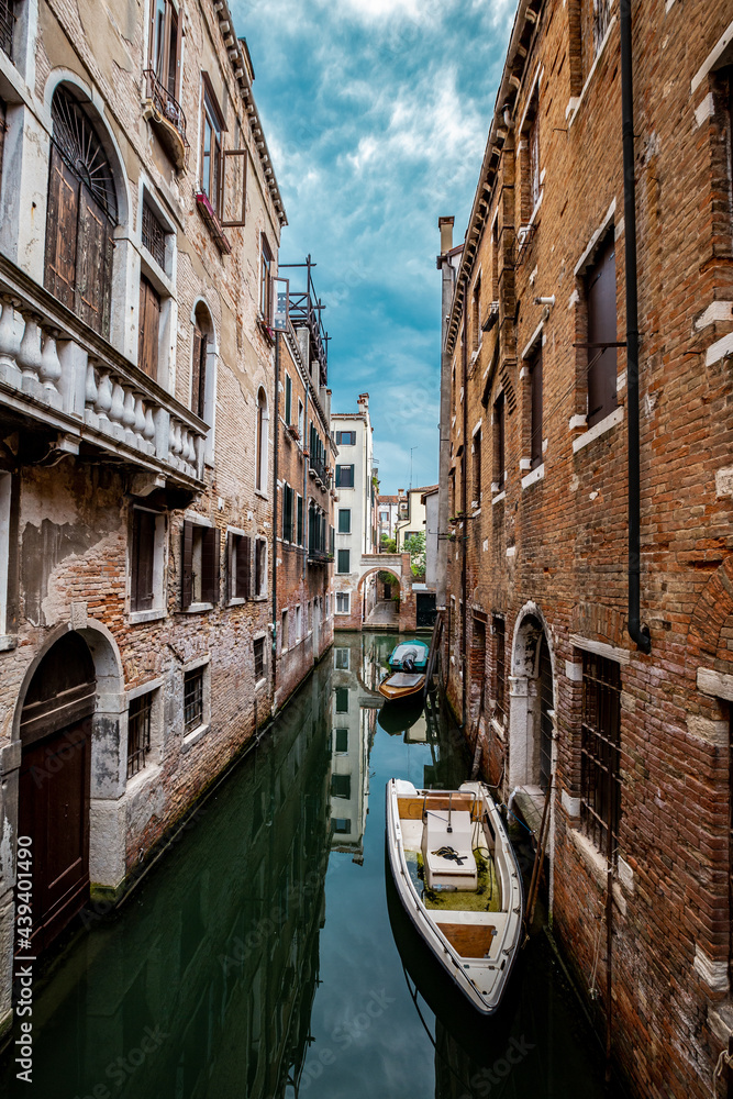 Street view of Venecia canal with boats and gondolas. Italy, Venice.