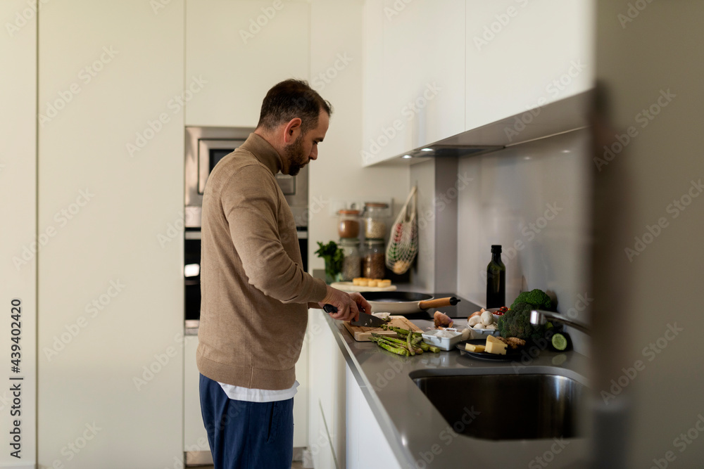 man cooking vegan dinner at home man cooking vegan dinner at home