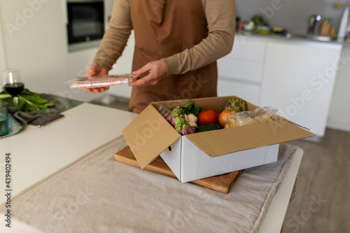 men open a delivery box meal kit
