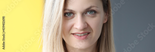 Portrait of smiling woman on gray background