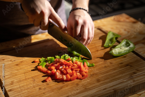 Man choping vegetables in kitchen photo