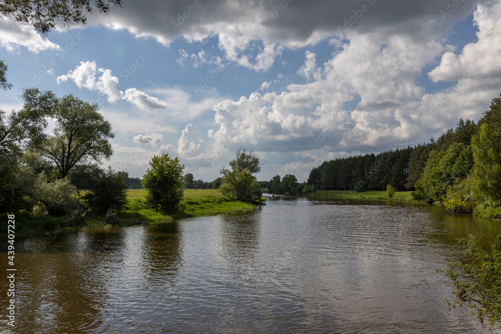 Summer landscape with river and clouds. Sunny day..Summer rural landscape on a sunny day, beautiful clouds in the sky. Summer landscape with river and clouds. Sunny day..Summer rural landscape on a sunny day, beautiful clouds in the sky.