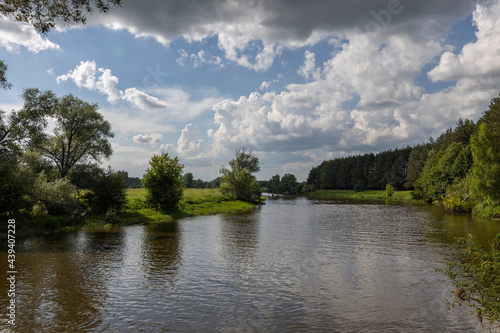 Summer landscape with river and clouds. Sunny day..Summer rural landscape on a sunny day, beautiful clouds in the sky.