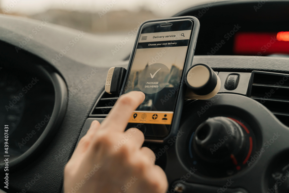 Close-Up Of Woman Using Delivery Application In Car. Close-Up Of Woman Using Delivery Application In Car.