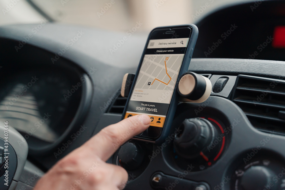 Close-Up Of Man Using Delivery Application In Car. Close-Up Of Man Using Delivery Application In Car.