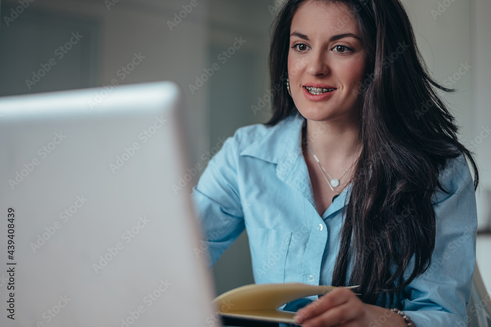 Young beautiful woman using a laptop while working in her office Young beautiful woman using a laptop while working in her office