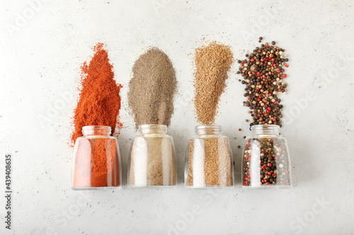 Fototapeta Naklejka Na Ścianę i Meble -  Jars with different spices on light background